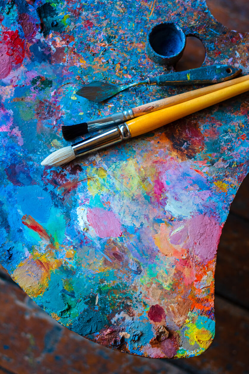 Colorful artist's palette with brushes and oil paints